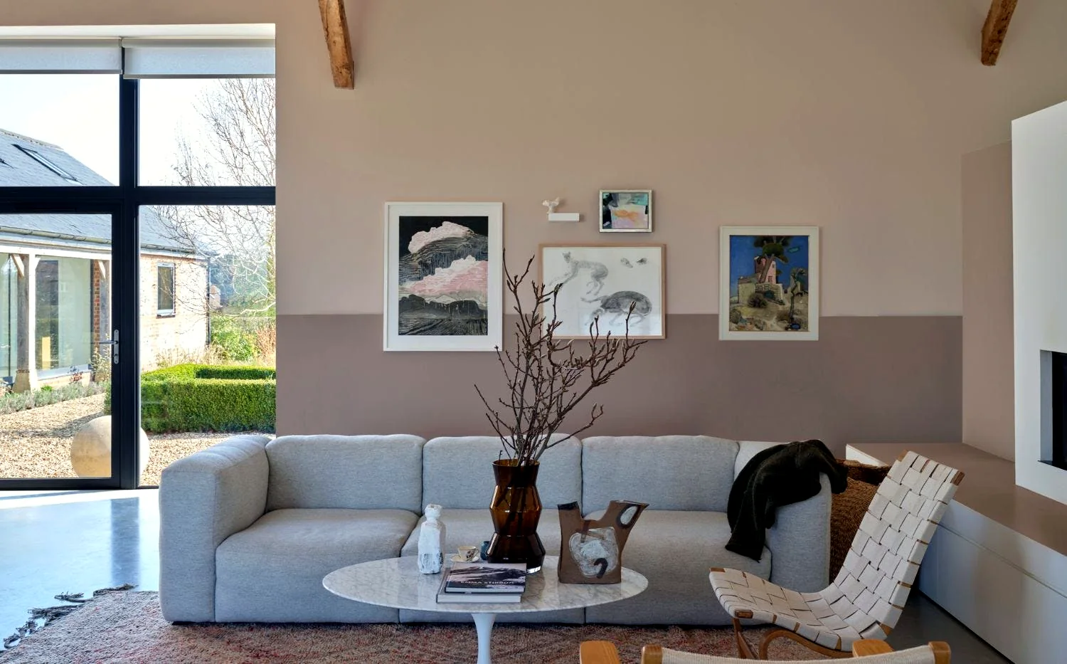 Beautifully painted living room with a warm terracotta accent wall and paint cans